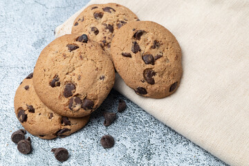Chocolate chip cookies on a table napkin, with copy space.