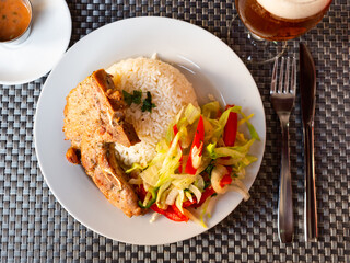 Pork chop with rice and vegetables. Latin American cuisine
