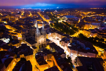 Picturesque aerial view of night Burgos cityscape overlooking Gothic steeples of Cathedral of Saint Mary, Spain..