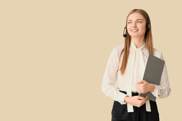 Female technical support agent in headset with clipboard on beige background