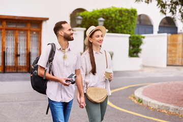 Happy, couple and tourist with camera outdoor for adventure, sightseeing and walking with holding...