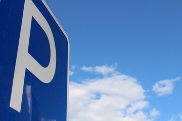 parking sign against blue sky
