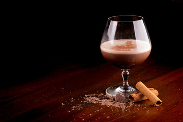 glass of chocolate cocktail with cognac and cinnamon coffee with chocolate shavings and cinnamon...