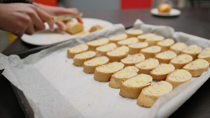 In a Home Kitchen A Girl Divide Cantucci Biscuits Before Second Baking