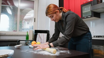 Young Woman Makes Dough On The Table Of A Sweet Food