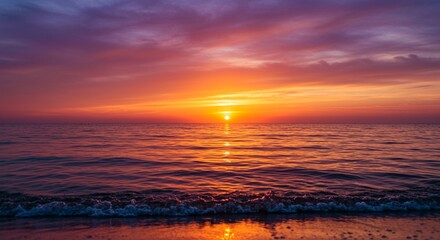 Fototapeta premium A vibrant sunset over the ocean with colorful clouds reflecting on the water surface at the beach
