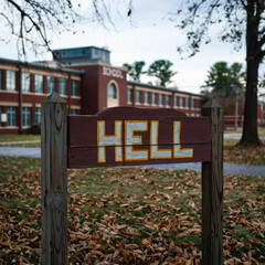 a sign saying hell is written near the school