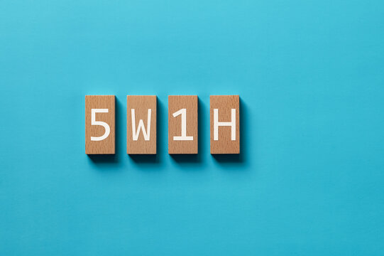 There is wood block with the word 5W1H. It is an abbreviation for When, Where, Who, What, Why, How as eye-catching image.