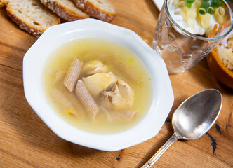 Delicious traditional chicken soup with pasta served in bowl