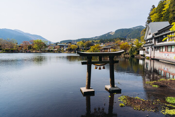 Kinrin lake in Yufuin town, Kinrin-ko lake, Oita prefecture, Japan, hot spring onsen resort town, with mount Yufu, Kyushu island region, rural mountain landscape, a spring day with a blue sky