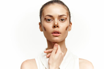 A close-up portrait of a model with beauty makeup showcasing flawless skin and a natural makeup look, highlighting emotions and style in a bright setting.