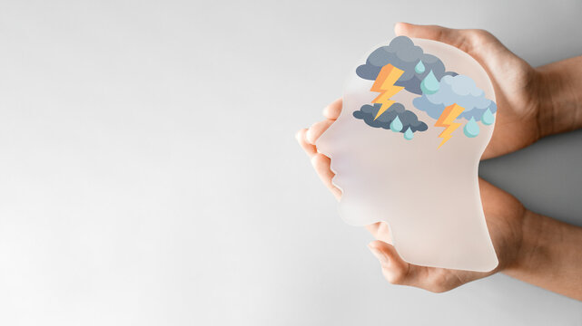 Hands holding head with thunder, mental health, burnout, depression, psychology concept
