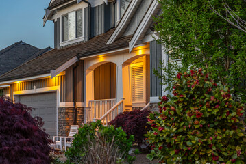 Entrance of luxury house with nice spring blossom landscape at night in Vancouver, Canada, North America. April 2025.