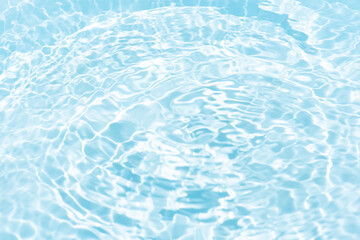 Blue water with ripples on the surface. Defocus blurred transparent blue colored clear calm water surface texture with splashes and bubbles. Water waves with shining pattern texture background.