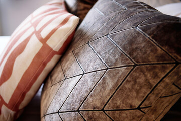 Pillows, fabric patterns and interior of hotel bed with duvet, comforter or design for accommodation. Closeup of empty bedroom, house or apartment at resort with stylish cushion, linen or home decor