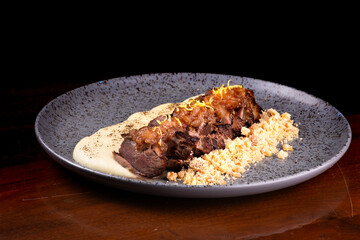 duck magret served with parmesan cream and gourmet farofa in angle