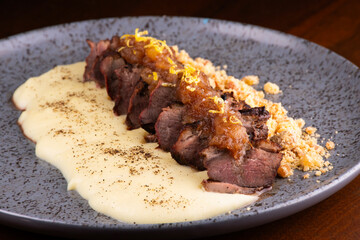 duck magret served with parmesan cream and gourmet farofa