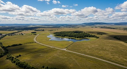 a lake in the middle of a green field