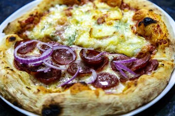 The most authentic Brazilian pizza, half pepperoni, onion and half four cheeses