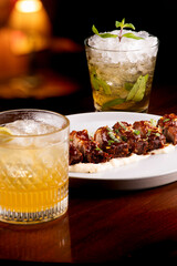 Pork pancetta starter dish with refreshing cocktails