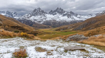 Alpine valley, snow-capped peaks.  Autumnal colors,  mountain landscape,  dramatic clouds