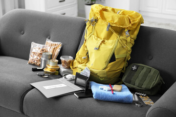 Survival kit. Different emergency supplies on sofa indoors
