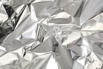 Crumpled aluminum foil as background, top view