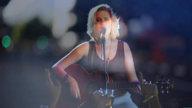 Teenage musician performing on stage, integrating music theme with animated guitar and hand icons