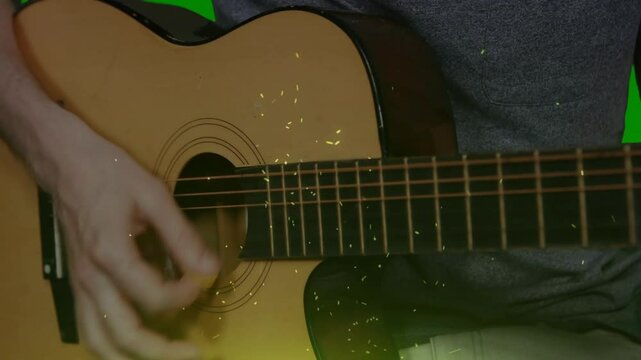 Acoustic guitar being strummed in close-up 3D render, featuring glowing particles on green backdrop