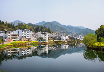 Peaceful Mountain Village Reflected in Water