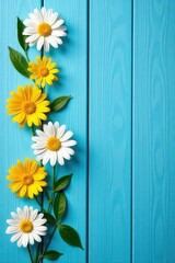 Fototapeta premium White daisy and yellow flower composition on blue painted wood planks, floral, sunflowers