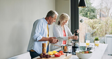 Elderly, couple and cooking in kitchen with tablet for meal prep, recipe idea and digital menu with smile. Senior, man and woman with technology at home for healthy food ingredients and diet planning © peopleimages.com