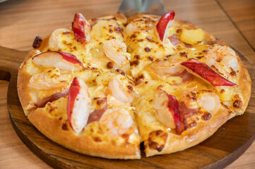 A seafood deluxe pizza serving on table. Pizza is a favorite food for many around the world.