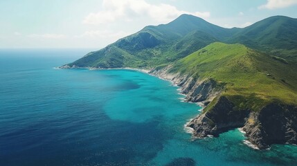 Fototapeta premium Aerial view Coastal mountain, turquoise ocean, sunny sky, idyllic beach