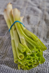 A bunch of scallions, sometimes called Spring Onions, Green Onions, or Long Onions,  on a kitchen...