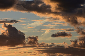 Contrails in the clouds at dusk