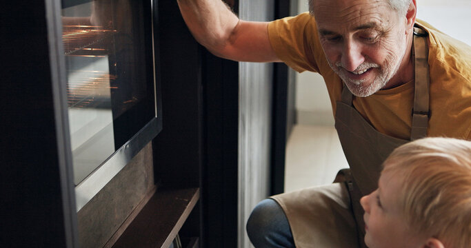 Oven, baking and mature man with child in kitchen watching cookies cooking together in home or retirement. Teaching, skills and development of kid with grandfather preparing dessert, food or dinner