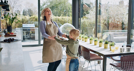 Happy, dance and grandmother with child in kitchen with celebration, energy and bonding in home....