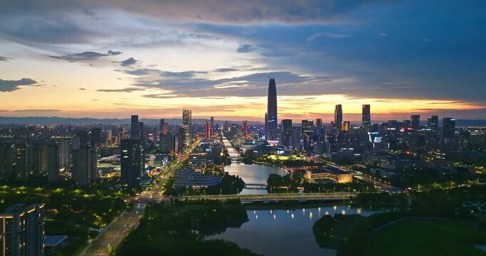 Aerial shot of a modern city skyline with skyscraper and river reflecting the colorful sunset sky in Ningbo, China.