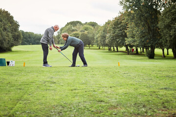 Sports, golf and senior man with coach for game, competition and practice on golfing course....