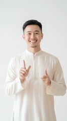 Smiling Asian Man Pointing Upwards and Giving Thumbs Up Gesture