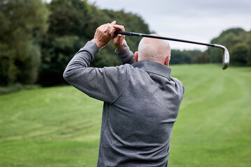 Golf, swing and senior man on grass for game, sports club and playing for weekend hobby in...