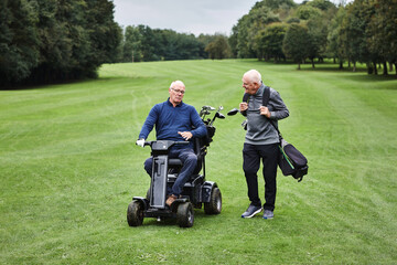 Sports, wheelchair and senior men on field for golf in game, match or competition on golfing course. Recreation, hobby and male with person with disability with club for training, fitness or practice