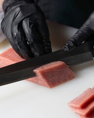 Slicing fresh tuna with precision sushi restaurant culinary art indoor kitchen close-up gourmet cuisine techniques