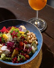 Colorful salad delight with fruity drink restaurant setting food photography elegant atmosphere close-up view culinary artistry