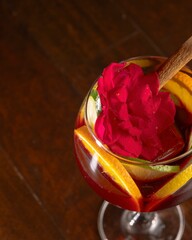 Refreshing sangria cocktail with citrus fruits and rose petal garnish bar setting drink photography warm atmosphere close-up view for culinary inspiration