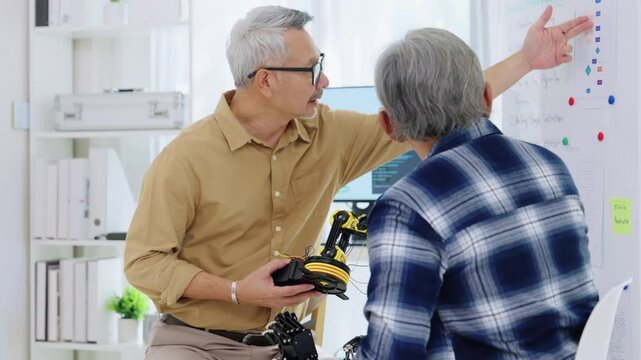 asian Engineers discussing robotics prototype with teamwork and innovation in artificial technology development