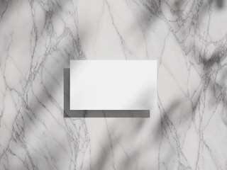 Elegant business card mockup on a marble background, featuring soft shadows for a refined look.