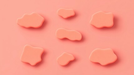 Fototapeta premium Abstract design featuring soft, coral-colored shapes against a peach background, creating a minimalist and modern aesthetic.
