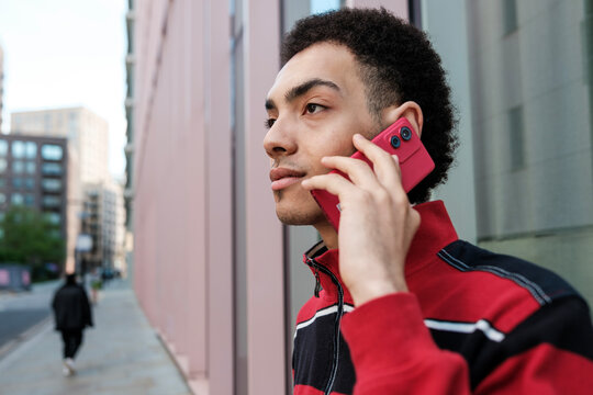 Young man talking on smartphone in urban setting